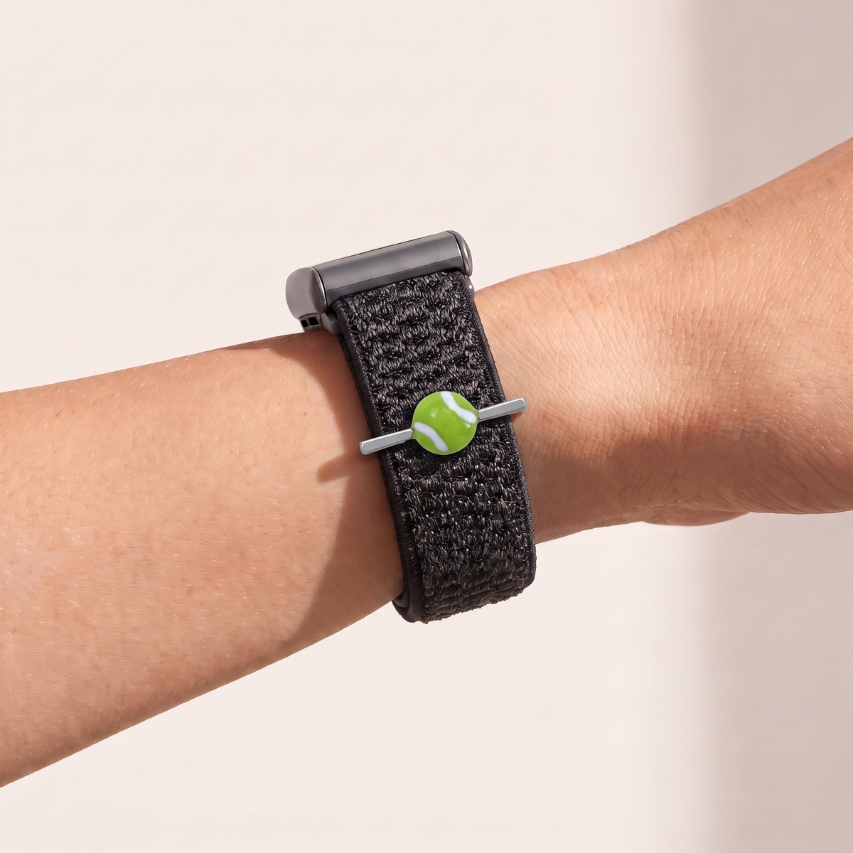 Charm Bar · Tennis Ball worn on a knit band